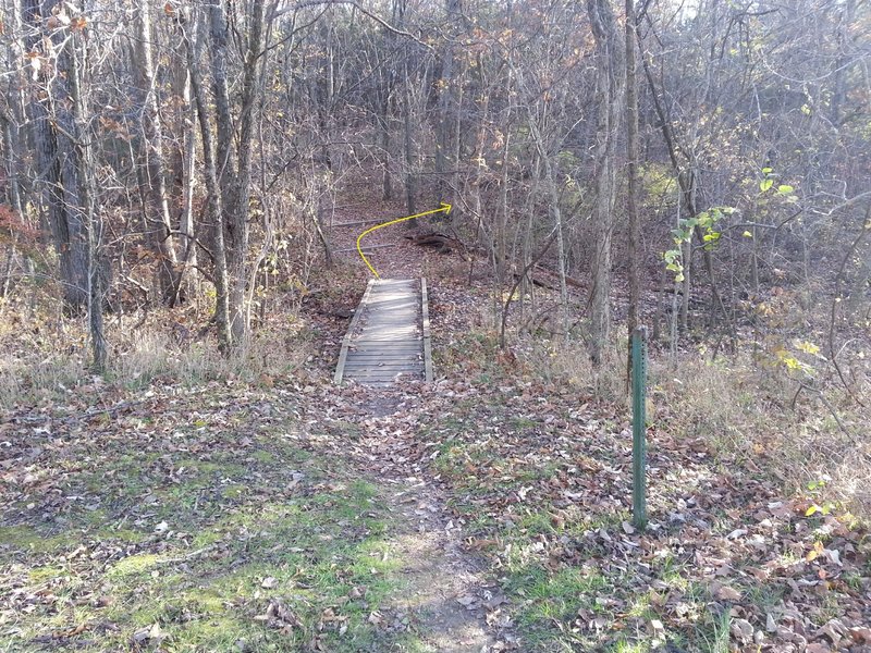 Take a right after the first railroad tie of the gravel hiking trail. The hiking trail leads to the bathroom and pavilion.