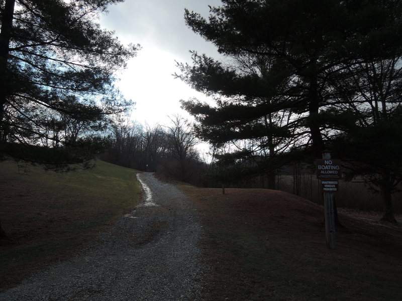 Gravel road with "No Boating Allowed" sign.  Marking the way to the singletrack.