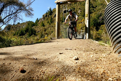 Crossing the swing bridge at the start of the Waihaha Mountain Bike Trail
