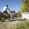 Passing through the squeeze gate at the start of the Orakau mountain bike trail