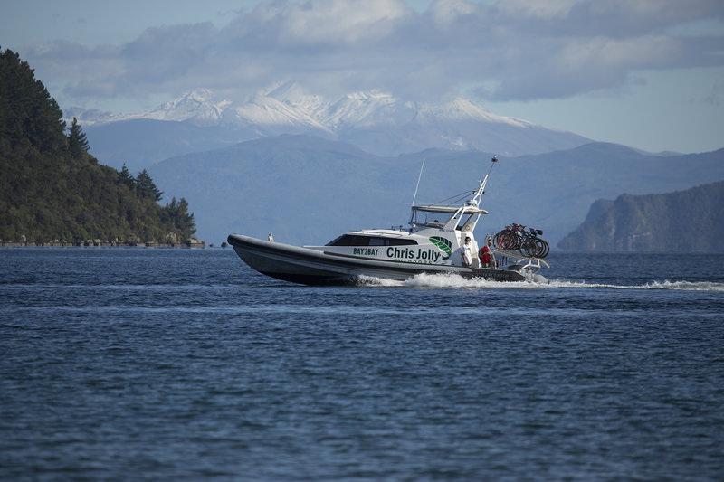 The Bay to Bay boat shuttle departing crossing in front of Mt Tongariro enroute to Kinloch from Kawakawa Bay