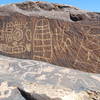 Below the edge of the cliff, passing pictograph panels.