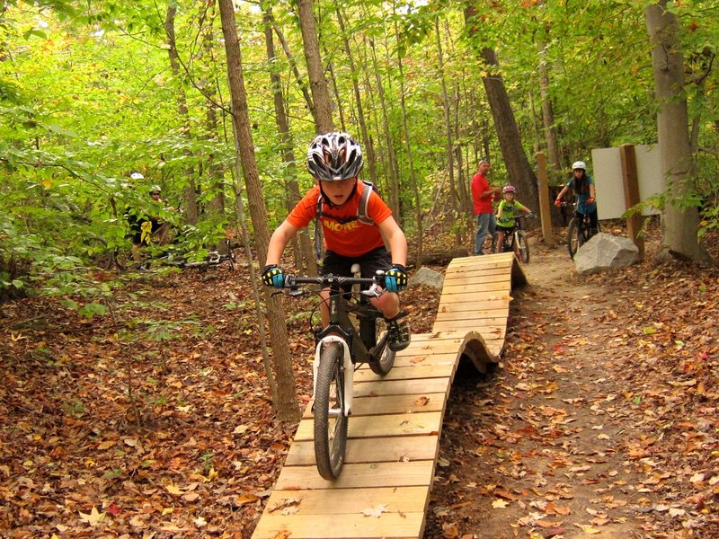 A young rider with MORE's sMORE's kids program dropping in on Boss Trail.