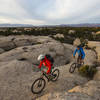 As the South Rim Trail turns back from the edge of Gooseberry Mesa, it traverses large islands of white slickrock.