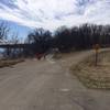 Singletrack start.  Start down the paved path.  Beginning is just past the road sign.