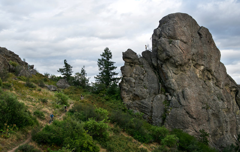 Riders passing beneath rock climbers during an Evergreen East group ride.