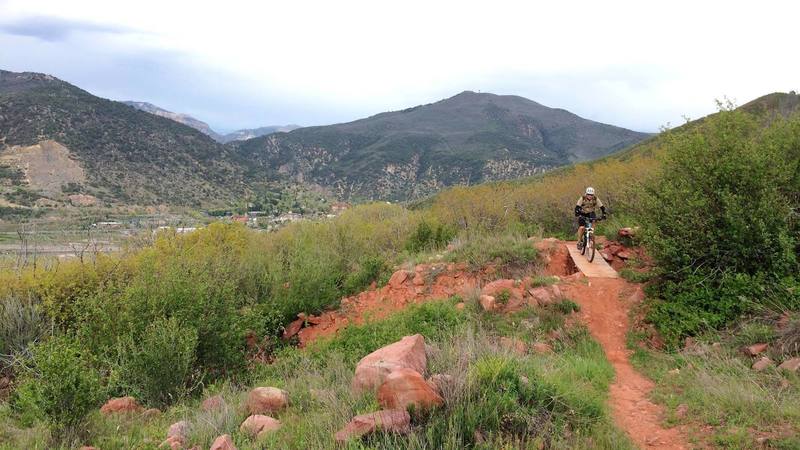 Rider heading northwest on the Defiance Trail.  Lookout Mountain & the Scout Trail are in the distance. Photo credit: Two Rivers Trails.