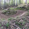 Early Spring view of the big 180 berm at Palmer Bike Park Flow Trail