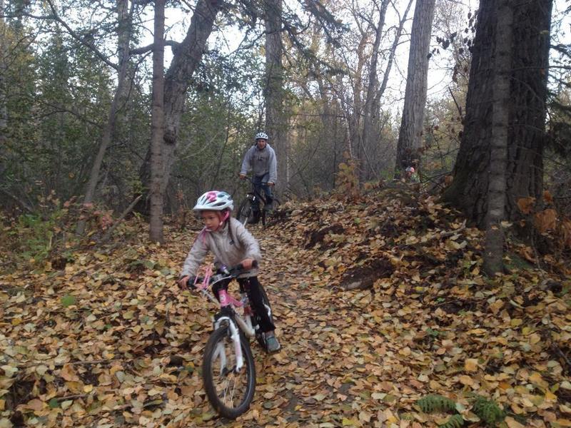 Family riders riding the "Tech Trail" in fall leaves