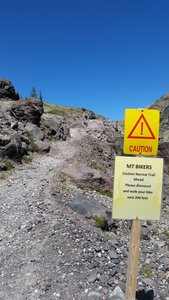 Trail narrows with a drop off on the right side.