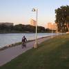 West side of the downtown river path, across from the Keeper of the Plains