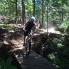 Riding over a bridge on Lower Basin XC