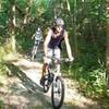 Bikers ride along a wooded section of the Cowboy Trail. (Photo by Nebraska Game and Parks with permission by Kirk Nelson, Assistant Division Administrator.)