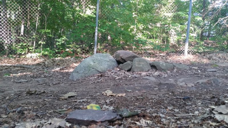 Rocks bump in the middle of the trail. View from the side of the trail.