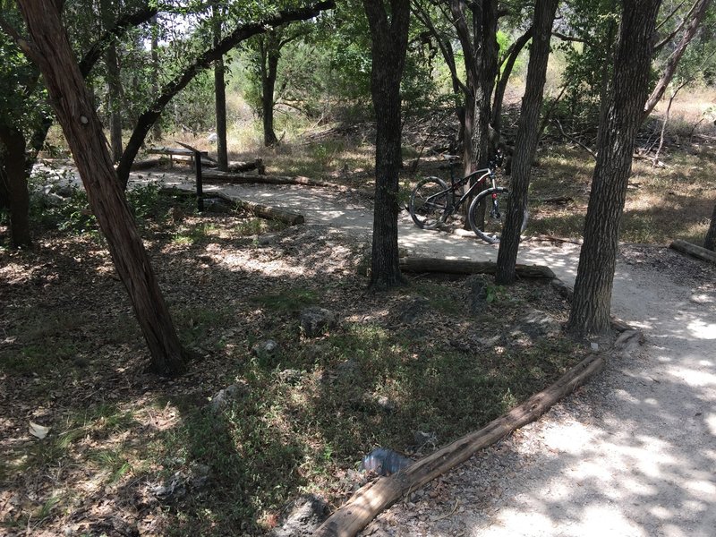 Virgil's Trail with informational kiosk about sinkholes and a bench to rest.