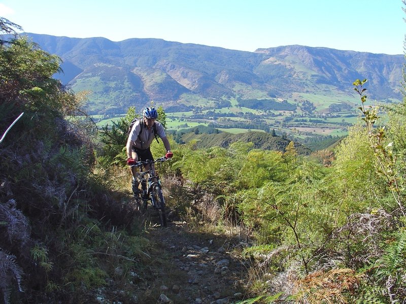 Gaining height above on Kill Devil Spur with views of the Takaka Valley opening up.