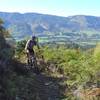 Gaining height above on Kill Devil Spur with views of the Takaka Valley opening up.