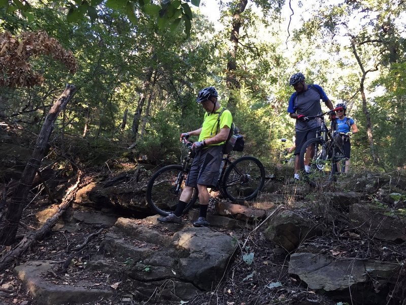 Some people could probably ride the descent, but beware there's barbed wire at the bottom.  This is where I think a re-route is in order.