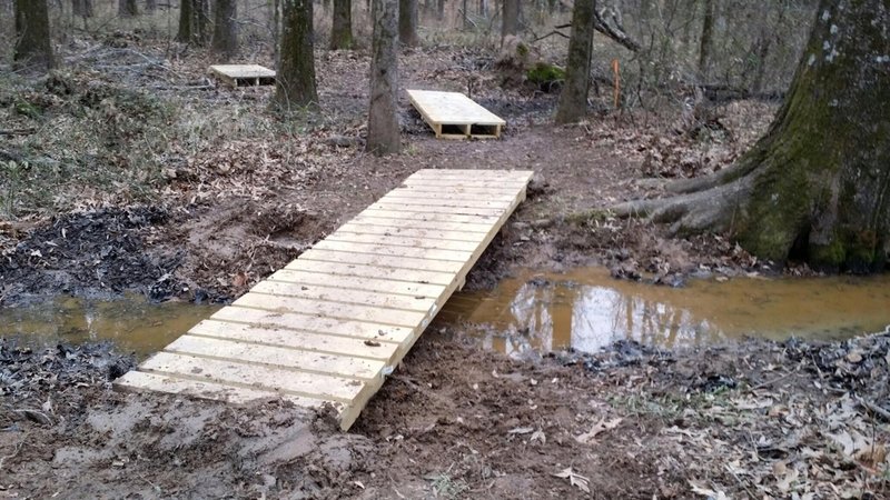 New bridges put in over water flowing off from the oil well to the west.