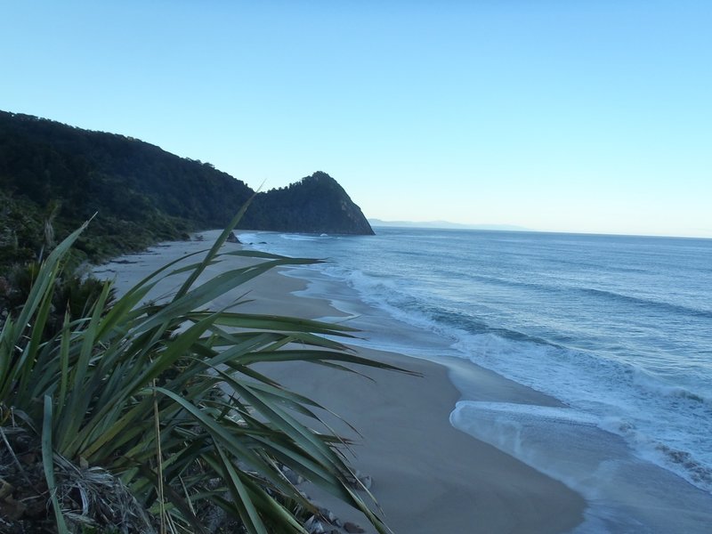 Early morning light on the sea looking back to Kohaihai Bluff at the south end of the Heaphy Track