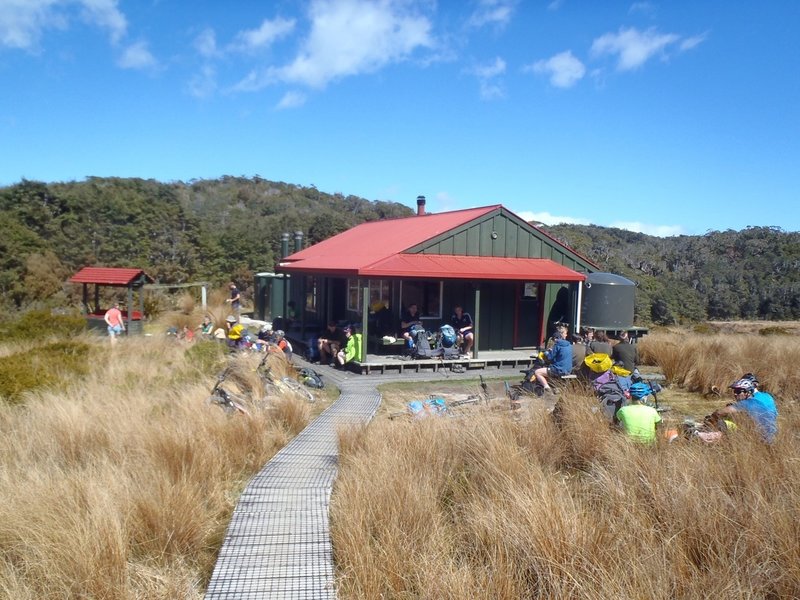 Trampers (what Kiwis call hikers) and mountainbikers stop for lunch at Saxon Hut.