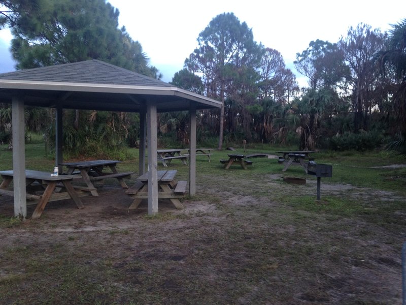 Picnic tables, baroque grill at the trailhead.