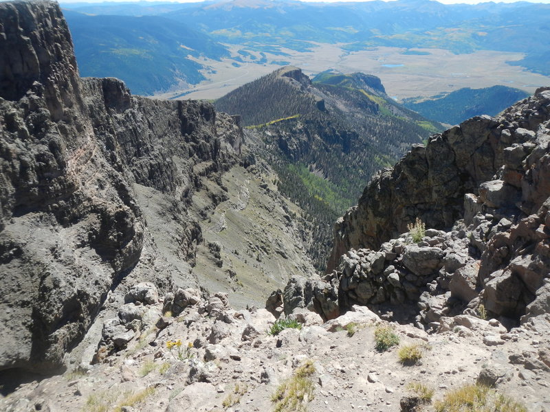 The plunging escarpment off Bristol Head (12706'). The road to Creede, Colo., is in the distance.