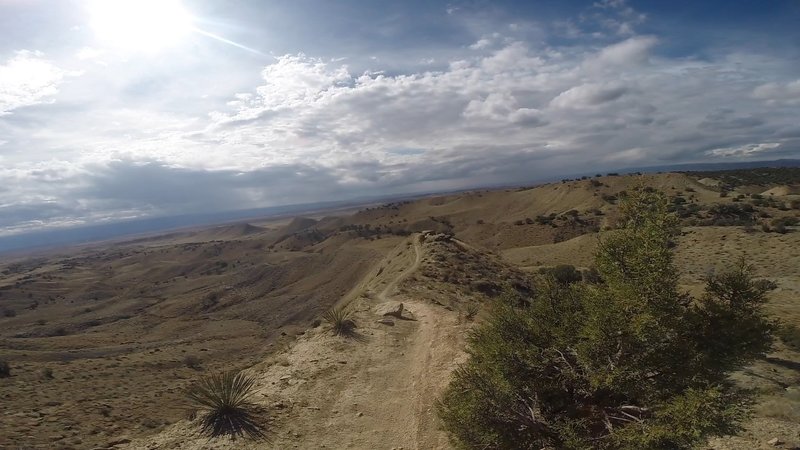 Along the thin ridge line just before a fast and straight descent into the flowy sections below.