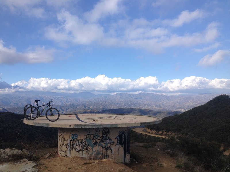 Cistern overlook where the fire road meets Camino Cielo. Trail continues to the right where the paved road turns to dirt again and is a steep hike-a-bike up.