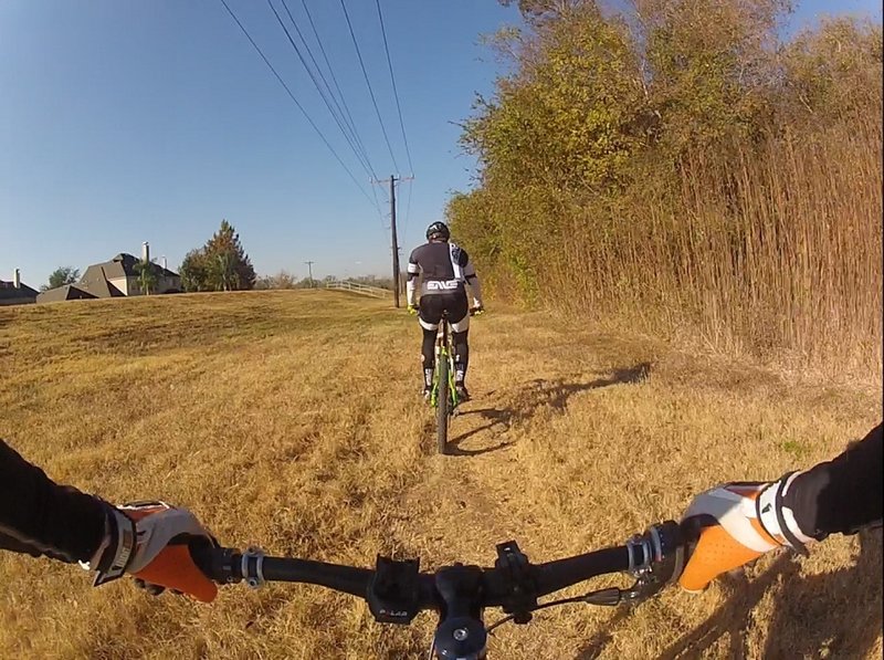 Ride along the powerlines for 200 yards until you come to the park benches on your right.  They signal the start of the singletrack section.