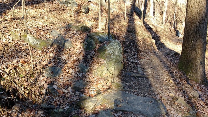 Steep rock drop exit of alternate high-line.