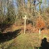 Not exactly where you would expect to find the Connector Trail sign. The sign sits beyond the brush against the tree line.