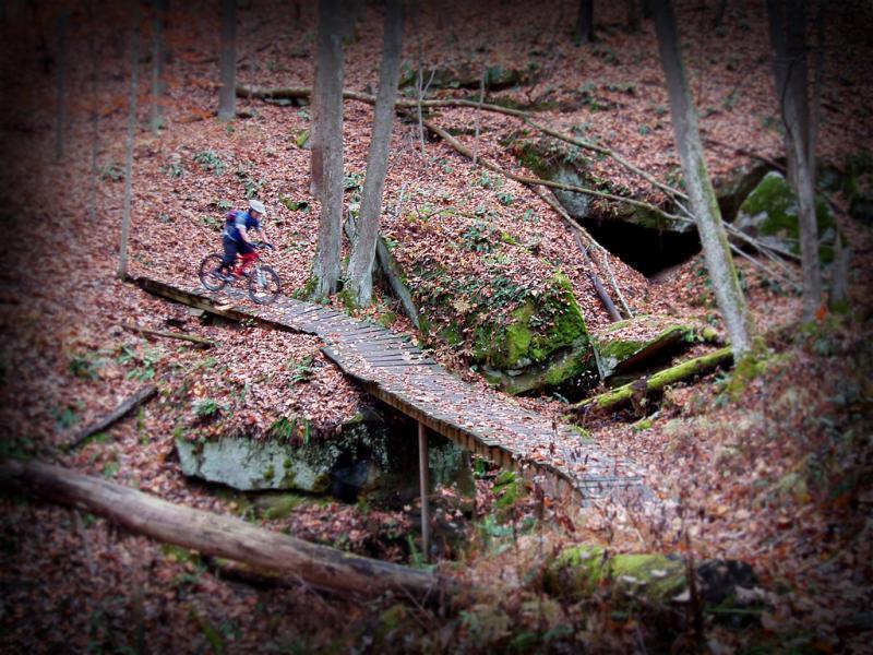 Bridge over rocks in front of cave entrance on Haystack Trail.