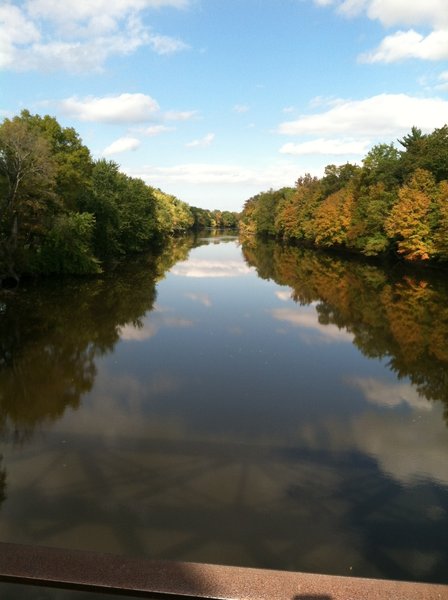 At mile 10.5 is the trail bridge at Springtown Road. It offers peaceful views of the often swiftly-moving Wallkill River as it flows north. You can see the shadow of the bridge on the water below in this photo.