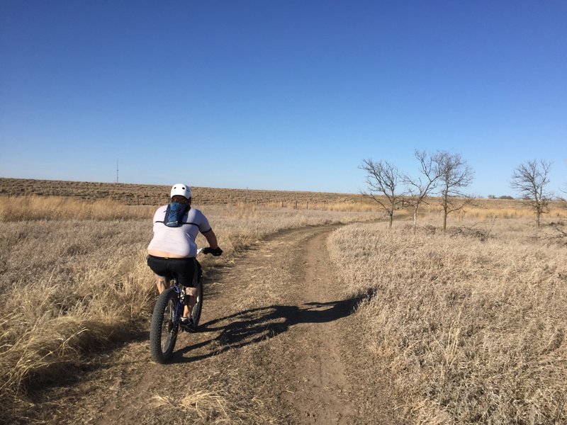 An doubletrack access road to get you from the trail to the paved path you can use in case of injury or mechanical issues.