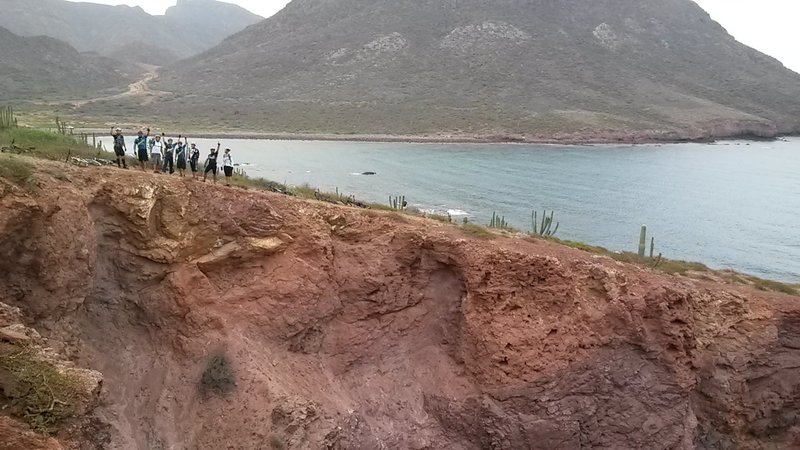 Happy MTB bikers on a track cliff.