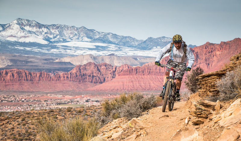 Rounding the corner on Sidewinder with the beautiful Snow Canyon and Pine Mountains in the background.