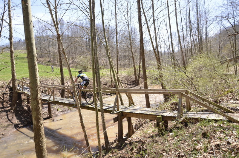 Racers cross the Walker Creek bridge during the Challenge At Mountwood WVMBA points series race.