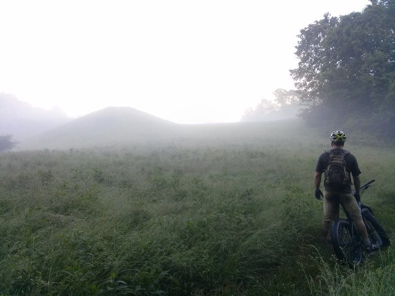 Fog rolls off the Mountwood Lake spillway onto Tomahawk Trail below the dam at dusk.