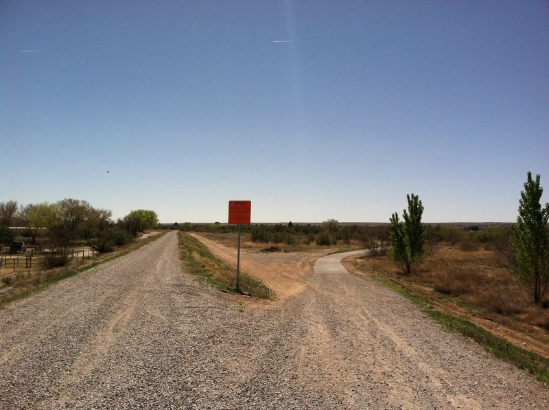 Here we have the terminal for the northern leg on the right where the poured concrete ends and the gravel begins. This incline to the river levee, straight ahead, runs behind me along the river for many more miles to the north. The Las Cruces day-use trail starts approximately 50 yards behind me.