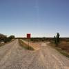 Here we have the terminal for the northern leg on the right where the poured concrete ends and the gravel begins. This incline to the river levee, straight ahead, runs behind me along the river for many more miles to the north. The Las Cruces day-use trail starts approximately 50 yards behind me.