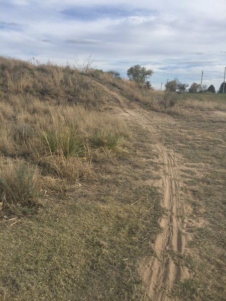 Uphill next to golf course.