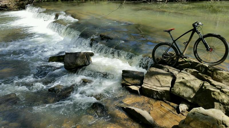 A secluded overlook provides a relaxing view of the shoals above Williams and Owen Forge Dam remnants.