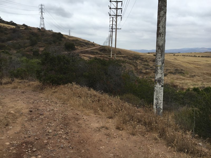 Stagecoach North Trail behind a small ridge and through a meadow.