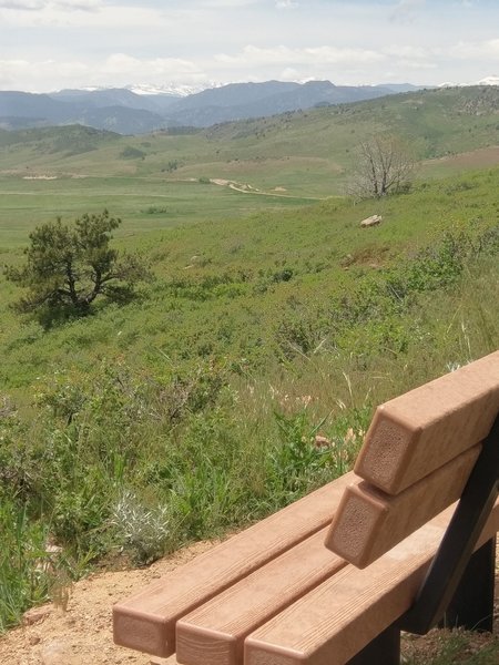 Snowy peaks in the distance from this well-placed bench