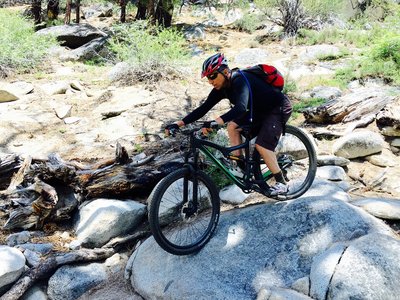 Amazing rock section on the Cold Creek Trail. There are two class V lines "expert" and "big air". Here is Jim "cleaning it".