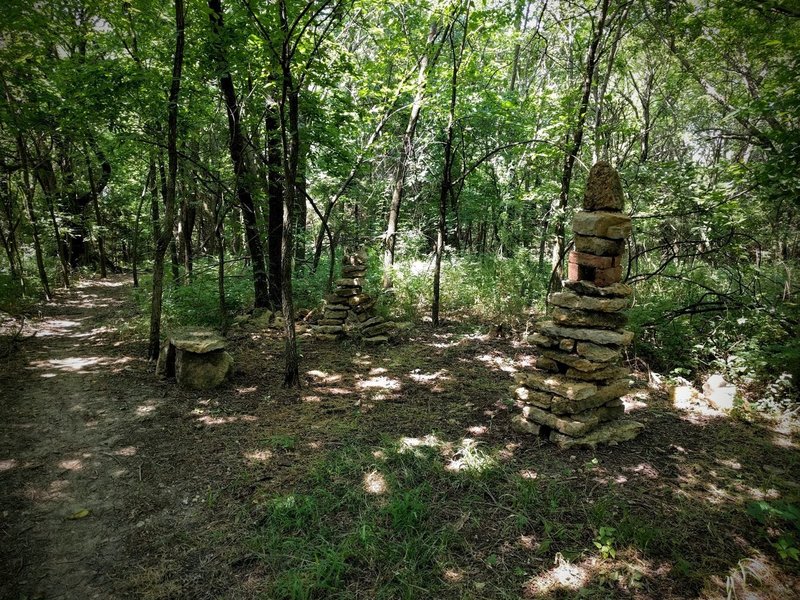 The rock cairn, a small arch, and a rustic bench on the Mt. Lehigh Trail at Lehigh Portland Trails.