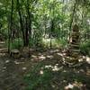 The rock cairn, a small arch, and a rustic bench on the Mt. Lehigh Trail at Lehigh Portland Trails.