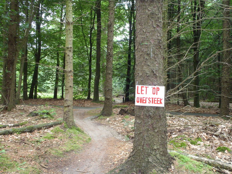 Warning sign just before a crossing. Throughout there are warning signs where needed. Translation: Watch out, crossing.