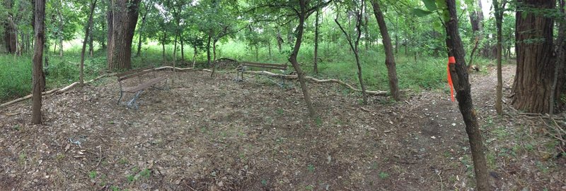 A meeting place with a couple of benches to wait for your buddies to catch up.